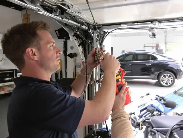 Powell Garage Door Repair safety certified technician performing cable replacement in Powell