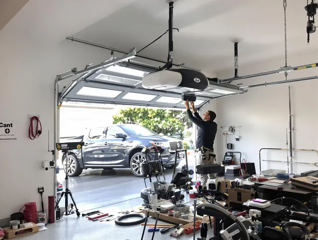 Powell Garage Door Repair specialist installing smart garage door opener system in Powell home