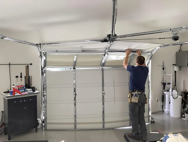 Powell Garage Door Repair specialist performing precise section replacement on Powell garage door